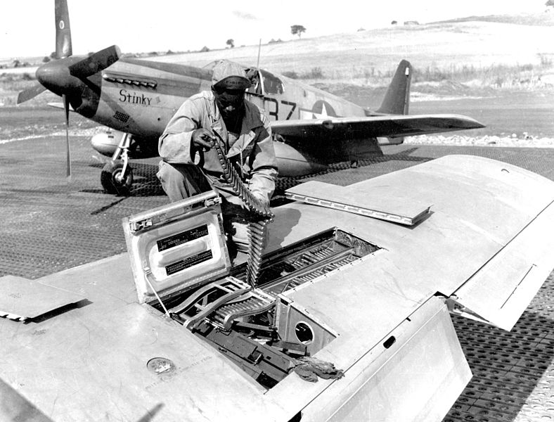 An armorer of the 332nd carefully preparing his P-51 for its next mission.
