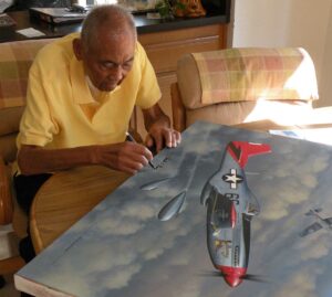 Claude Davis in 2012 signing Stan Stoke's painting of Bob Friend’s P-51D “Bunny”.
